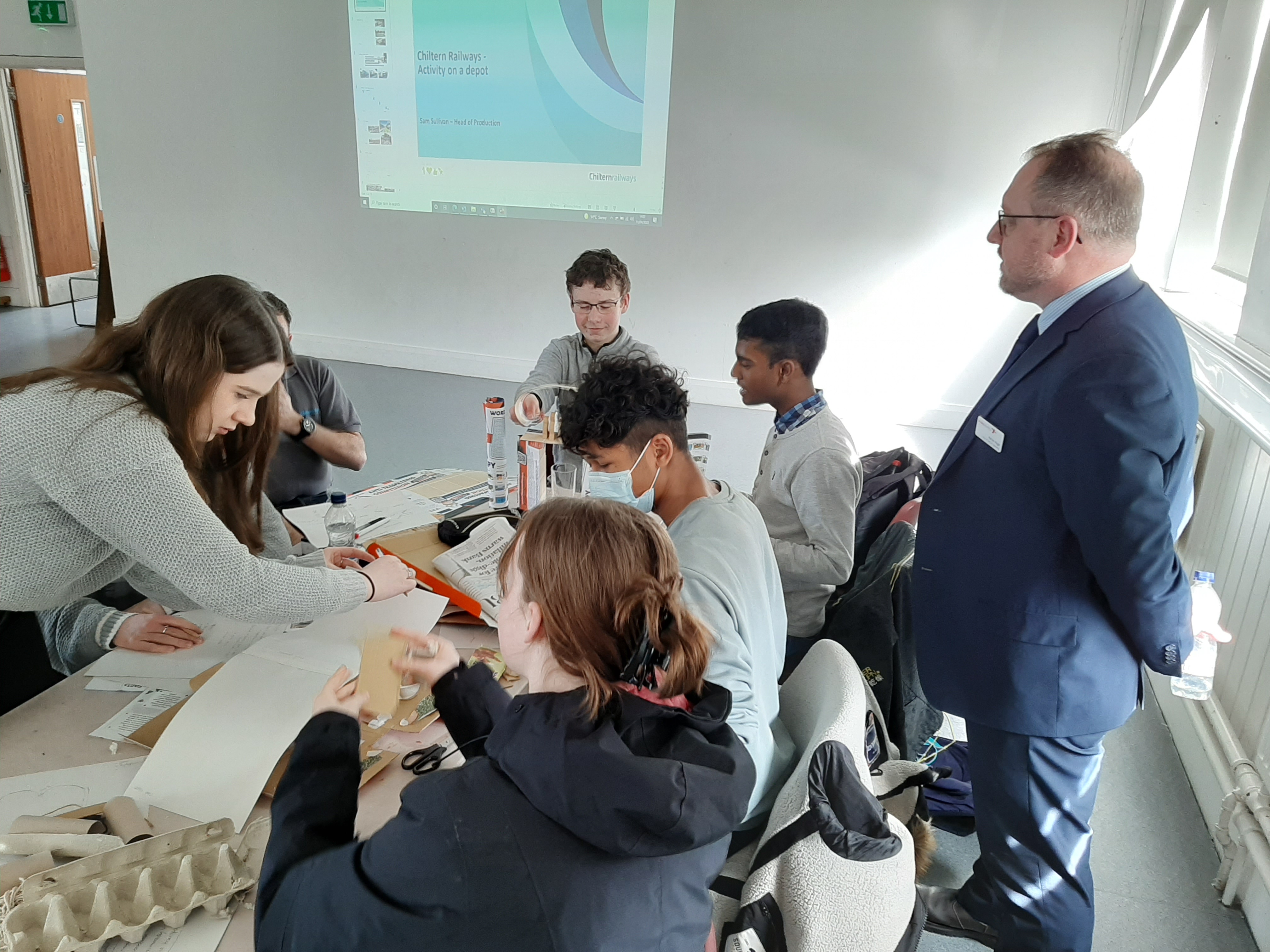 A group of students work around a table