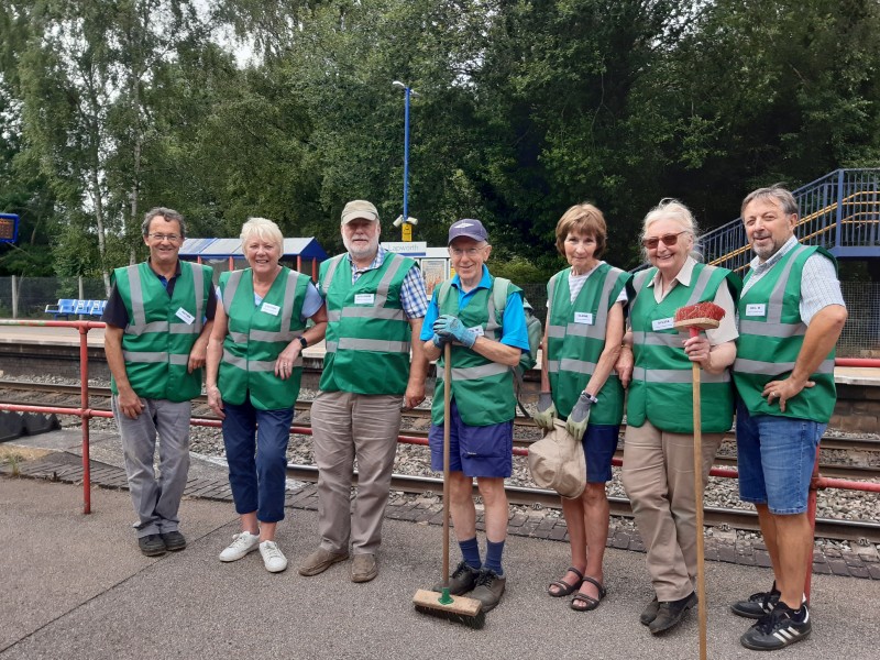 A group of volunteers on a train station platform