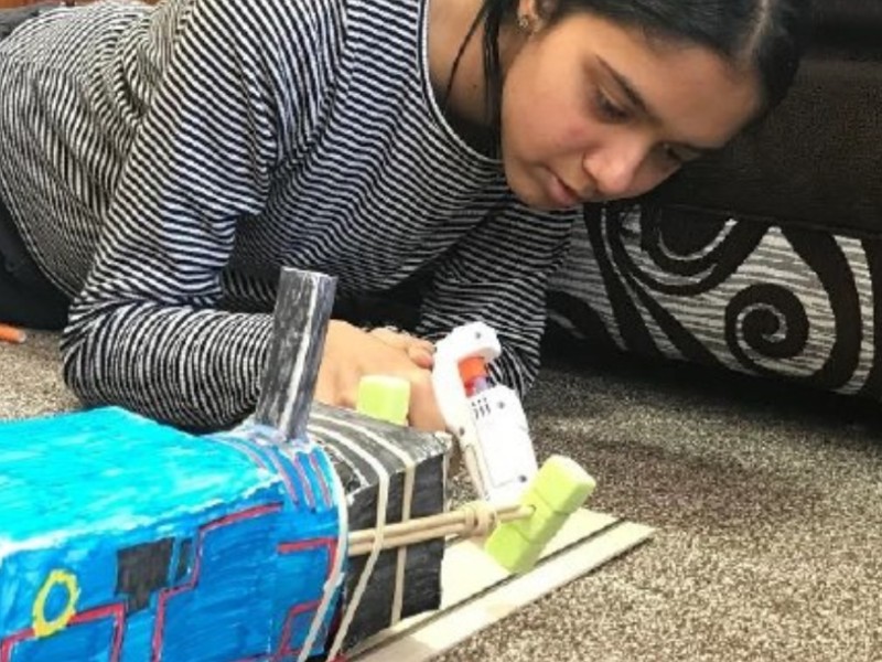 A child making a Thomas the tanked engine model